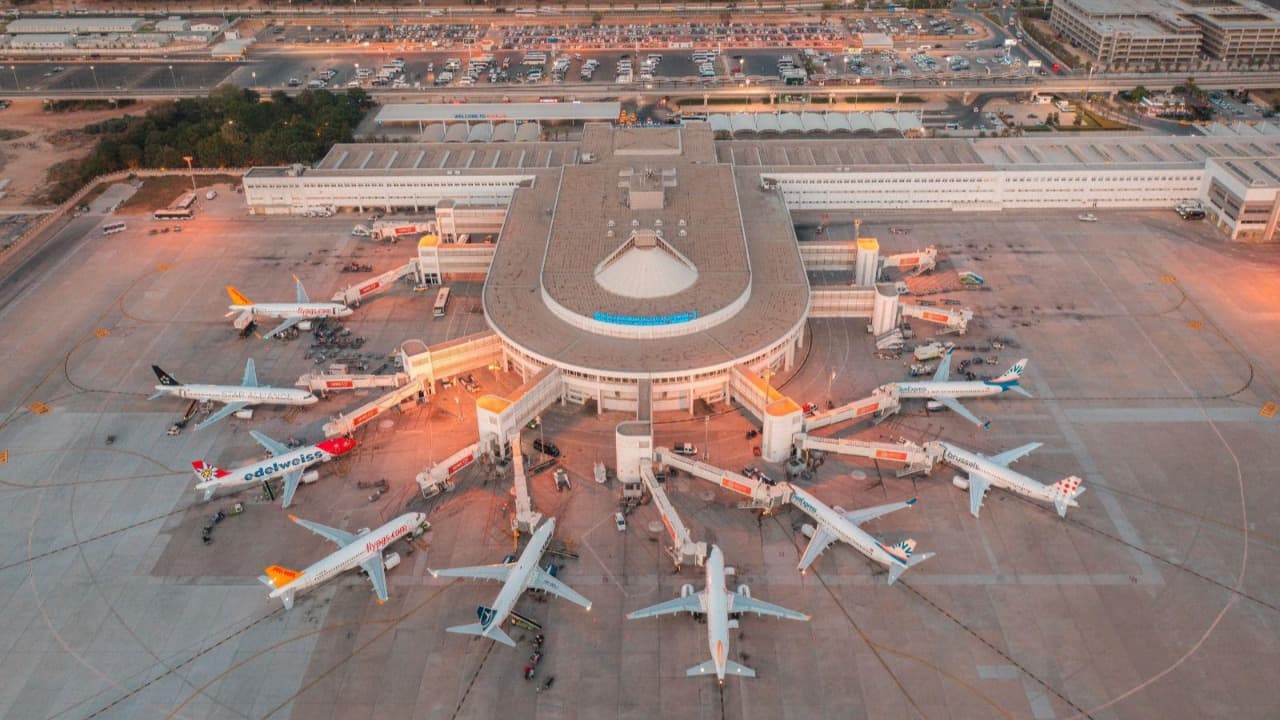 Aerial view of Antalya Airport terminal with aircraft at the gates